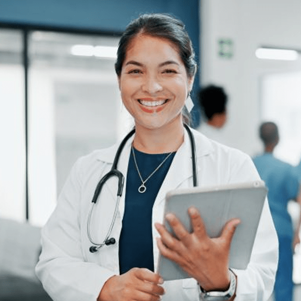 Female doctor holding a patient chart and smiling